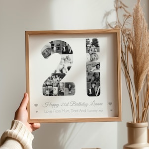 May include: A framed photo collage in black and white, featuring a photo mosaic of the number 21. The text "Happy 21st Birthday Leanne Love From Mum, Dad And Tommy xxx" is printed below the collage.