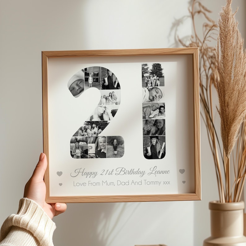 May include: A framed photo collage in black and white, featuring a photo mosaic of the number 21. The text "Happy 21st Birthday Leanne Love From Mum, Dad And Tommy xxx" is printed below the collage.