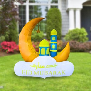 May include: An inflatable Eid Mubarak decoration featuring a yellow crescent moon, a blue mosque, and a white cloud with the text "Eid Mubarak" in Arabic and English.