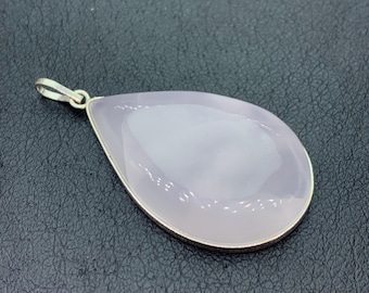 May include: A teardrop-shaped pendant with a pale lavender gemstone, set in a silver-colored metal frame. The pendant has a loop at the top for a chain. The gemstone is smooth and polished, reflecting light.