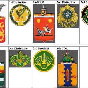 May include: A collection of military patches, including coat of arms (COA), distinctive unit insignia, and shoulder sleeve insignia. The patches feature various designs, colors, and symbols, such as eagles, cannons, and fleur-de-lis.