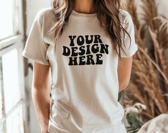 May include: A white t-shirt with the text "YOUR DESIGN HERE" in black, retro-style lettering.