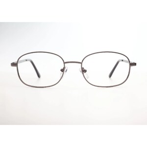 Puede incluir: Un par de gafas de vista de forma ovalada con un marco de metal marrón.