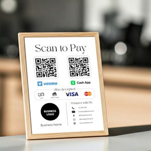 Op de afbeelding: Een ingelijste bord met de tekst "Scan to Pay" en twee QR-codes. Het toont betalingsopties zoals Venmo, Cash App en Visa. Het bord bevat ook een bedrijfslogo, bedrijfsnaam en contactgegevens.
