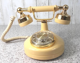Teléfono rotatorio vintage color crema de mantequilla con diseño de celebridad - 1980 - Funciona