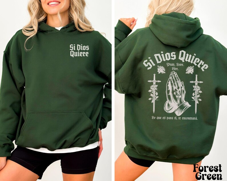 May include: A dark green hooded sweatshirt with the text "Si Dios Quiere" printed on the front and back. The back design includes a pair of hands in a praying position, two swords, and roses.
