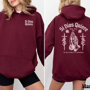 May include: Maroon hoodie with a white graphic print that says "Si Dios Quiere" with a praying hands design and the text "Pray, Love, Live. Yo que es para ti, te encontrara."