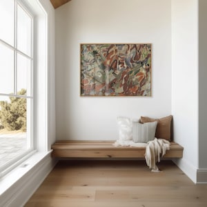 May include: A modern interior scene featuring a wooden bench with pillows and a blanket beneath an abstract painting in a wooden frame. The room has a large window and light-colored hardwood flooring.