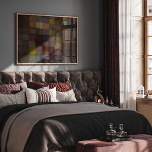 May include: A bedroom scene featuring a tufted headboard, a bed with a black comforter and a gray blanket, and decorative pillows. A framed abstract painting hangs above the bed. The room is decorated with dark red curtains and a small ottoman.