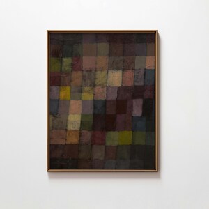 May include: Abstract painting in a gold frame. The artwork features a grid of various colored squares, including shades of brown, green, purple, and yellow. The painting has a textured appearance, suggesting the use of thick paint or mixed media.