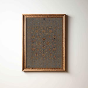 Puede incluir: Impresión enmarcada con un diseño detallado de alfombra vintage. La alfombra tiene un fondo azul oscuro con un patrón floral repetido en tonos dorados y óxido. El marco es de madera natural.