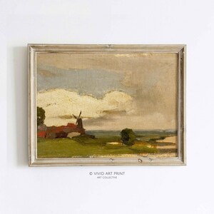 Könnte beinhalten: Ein Landschaftsgemälde im antiken Stil mit einer Windmühle und einem bewölkten Himmel. Das Kunstwerk ist in einem hellfarbigen Holzrahmen gerahmt. Das Gemälde hat eine Vintage-Ästhetik mit Fokus auf natürliche Elemente. Der Text "VIVID ART PRINT ART COLLECTIVE" befindet sich unten.