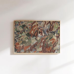 May include: Abstract painting in a wooden frame. The artwork features a mix of colors, including shades of brown, green, and blue. The brushstrokes create a textured appearance, with the colors blending together to form an abstract composition. The painting is displayed on a white wall.