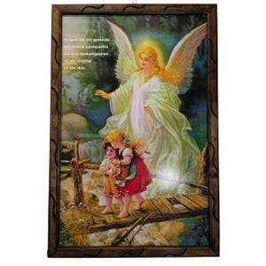 May include: A framed religious print with a painting of an angel with wings, wearing a white gown, standing over two children on a wooden bridge. The text in the image reads "Angel de mi guarda mi dulce compañia no me desampares ni de noche ni de dia."
