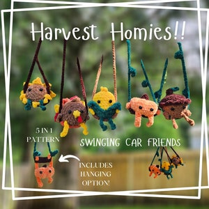 May include: Five crocheted plush toys hanging from strings, each representing a different harvest theme: a sunflower, a turkey, a pumpkin, a carrot, and an acorn. The toys are labeled "Harvest Homies!" and "Swinging Car Friends". The text "5 in 1 Pattern" and "Includes Hanging Option!" are also included in the image.