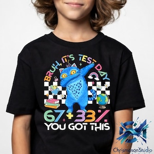 May include: Black t-shirt with a blue cat dabbing, and the words "Bruh, It's Test Day." The shirt also has the text "67+33% You Got This" in various colours, plus a rainbow, globe, and books.