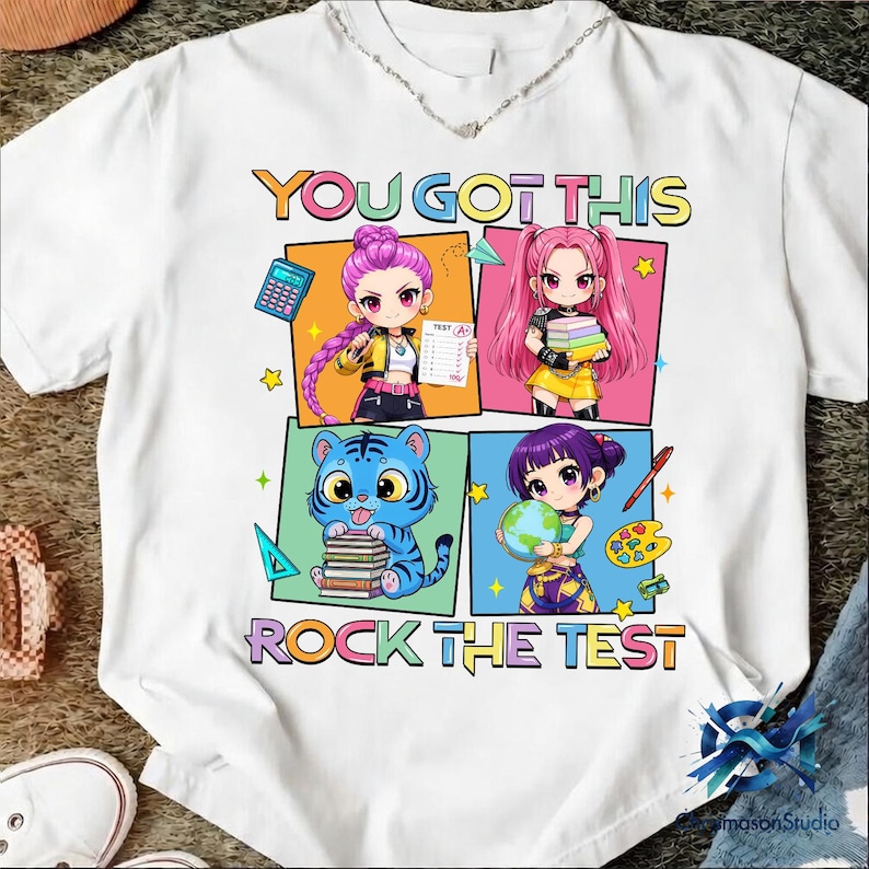 May include: White t-shirt with the text "YOU GOT THIS" and "ROCK THE TEST" in colorful block letters. The shirt features four anime-style illustrations of students with school supplies, including a calculator, books, and a globe.