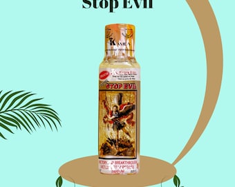 May include: A brown glass bottle with a gold label that says "Stop Evil" and features an image of an angel. The bottle is labeled "Total Extra Juice" and "Victory & Breakthrough".