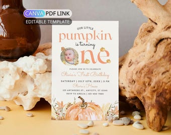May include: A printable invitation with the text "Our Little Pumpkin is turning one." The invitation features a photo of a baby, pumpkins, and floral illustrations. The details include the birthday date, time, and location.