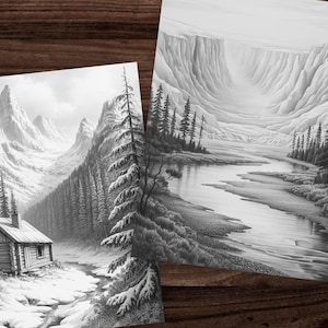 May include: Two black and white landscape art prints. One print depicts a cabin nestled in a snowy mountain scene with tall pine trees. The other print shows a river winding through a canyon with trees along the banks.