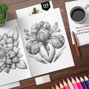 以下が含まれることがあります： 2つの詳細な白黒の花のイラストが描かれた開いた塗り絵。本は白い表紙で、「150ページ」という文字が印刷されています。本は、コーヒーカップ、鉛筆、色鉛筆のセットが置かれた木製の表面の上に置かれています。