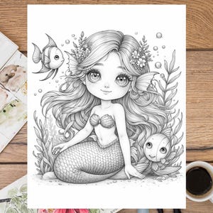 May include: A black and white illustration of a mermaid with long flowing hair, a seashell bra, and a fishtail. She is surrounded by seaweed and two fish.