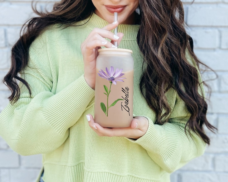 Glass jar girl holding cup for cold coffee