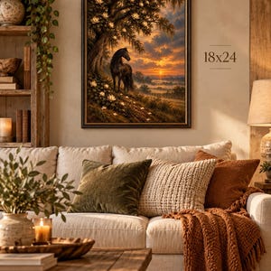 Vintage equestrian wall art with black horse, magnolia tree and glowing sunset displayed above a cozy neutral sofa.