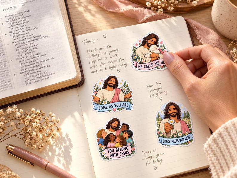 Jesus-themed journal
Prayer journal beside an open Bible, decorated with illustrated Jesus stickers showing a lamb, children, welcoming arms, and a daisy. A hand places a sticker.