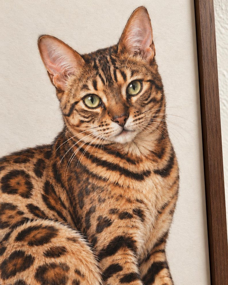 Close-up mockup of the printed Bengal cat’s green eyes, golden fur, dark facial markings, and fine whiskers, with a walnut frame edge visible on the right.