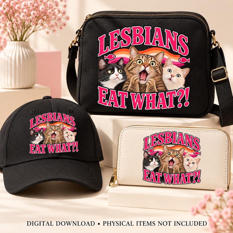 Black baseball cap, cream zip wallet, and black crossbody purse displaying the pink “Lesbians Eat What?!” cat design on cream display stands.
