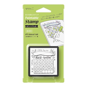 Puede incluir: Un sello negro y blanco con un diseño de calendario y el texto "Let's try it! habit tracker" sobre un fondo verde. El sello está etiquetado como "Paintable Stamp" y "Oil-based ink".
