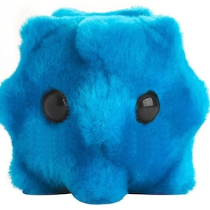 May include: A bright blue plush toy with a soft, fuzzy texture and a rounded, irregular shape. The object features two large, smooth, black circular eyes positioned on the front, giving it a distinct appearance against the vibrant blue fur.