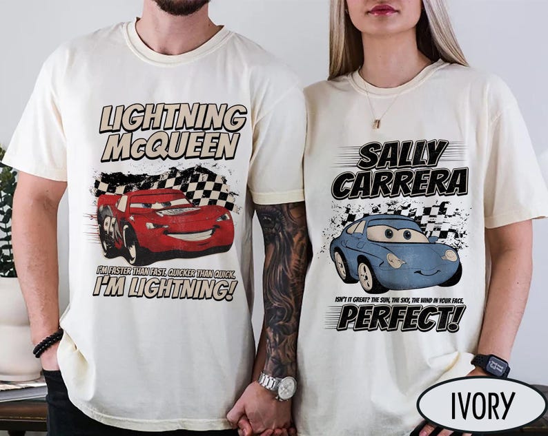 May include: Ivory-colored t-shirts featuring Lightning McQueen and Sally Carrera from the Cars movie. The Lightning McQueen shirt has the text "I'M LIGHTNING!" and the Sally Carrera shirt says "PERFECT!"