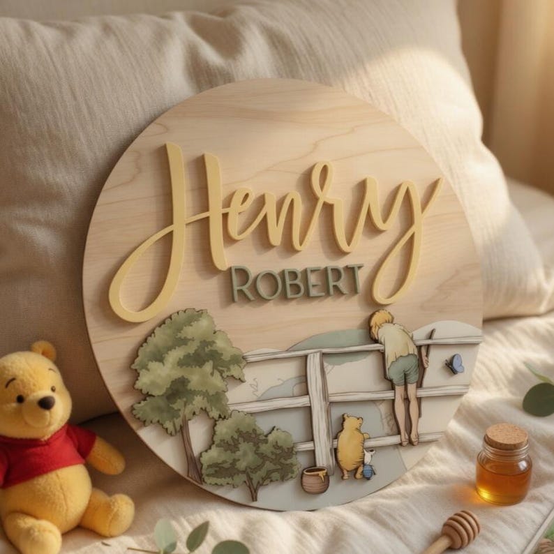 May include: A circular wooden wall sign featuring the name Henry Robert in raised yellow and green lettering. The design includes a layered illustration of a person and a bear standing by a wooden fence near trees, with a small blue butterfly.