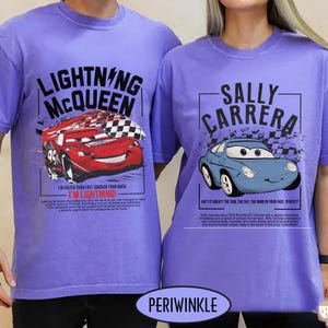 May include: Periwinkle t-shirts featuring Lightning McQueen and Sally Carrera from the Cars movie. The Lightning McQueen shirt has a red race car graphic with text. The Sally Carrera shirt has a blue car graphic with text.