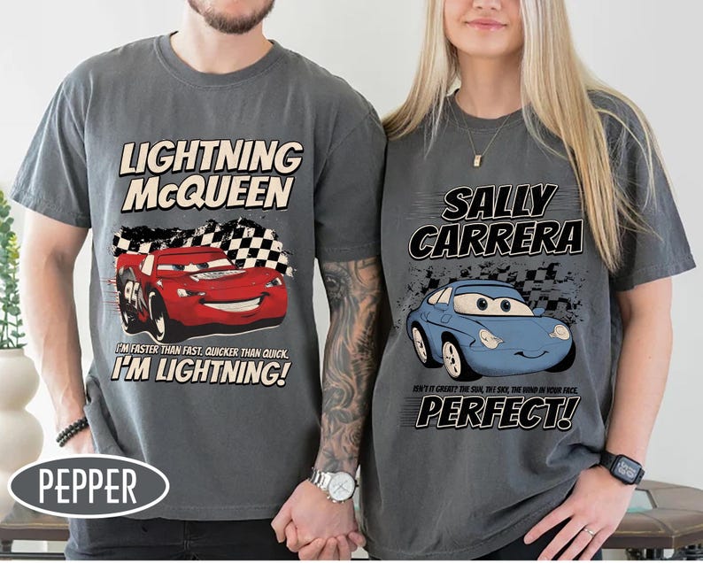 May include: Two gray t-shirts featuring characters from the movie Cars. One shirt has Lightning McQueen with the text "I'm faster than fast, quicker than quick, I'm Lightning!" The other has Sally Carrera with the text "Perfect!"