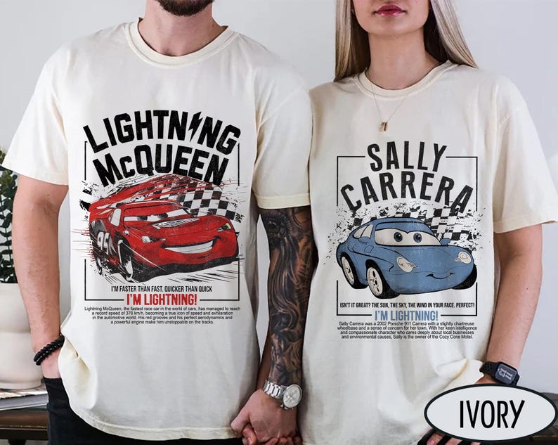 May include: Ivory-colored t-shirts featuring Lightning McQueen and Sally Carrera from the Cars movie. The Lightning McQueen shirt has a red race car graphic and text. The Sally Carrera shirt has a blue car graphic and text.