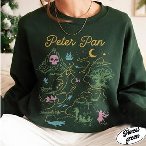 May include: A white ceramic mug with a black handle and the text "But First, Coffee" in a bold, black font. The mug is set against a blurred background, suggesting a cosy setting.