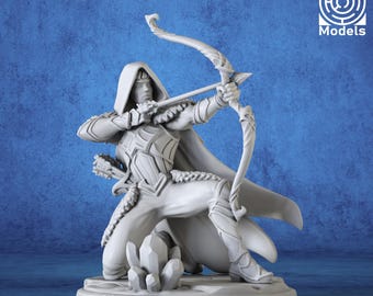 May include: A gray miniature figure of an archer in a hooded cloak, drawing a bow. The figure is kneeling on a base with the text "3D Miniatures Factory". The background is a textured blue.