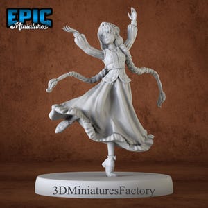 May include: A gray, unpainted miniature figurine of a woman wearing a long dress and a braid. She is posed in a dancing position with her arms raised above her head. The base of the figurine is a round platform with the text "3D Miniatures Factory" printed on it.