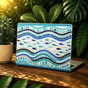 May include: A laptop skin featuring a mosaic design of wavy blue and turquoise bands. The pattern includes small, scattered fish shapes in various shades of blue, white, and dark navy, arranged across a light background between the flowing, colorful mosaic waves.