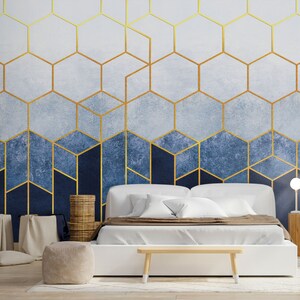 a modern bedroom with a blue and gold wallpaper