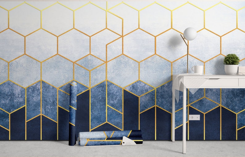 a room with a blue and gold wallpaper and a white table