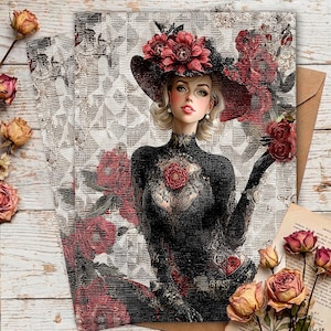 May include: Illustration of a woman in a black dress and hat adorned with red flowers. The artwork is on a card with a floral and geometric background. Dried roses and a brown envelope are also present.