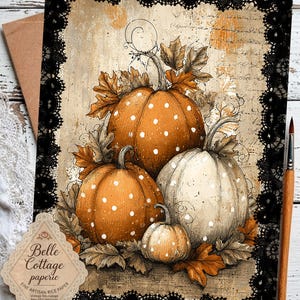 May include: A rectangular sheet of decoupage rice paper featuring a central illustration of three pumpkins with white polka dots, surrounded by autumn leaves. The design is framed by a black lace border and includes vintage script text.