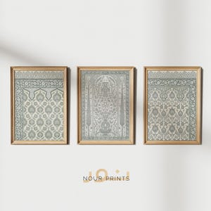 May include: Three framed prints of intricate, traditional Islamic prayer rugs with a light blue and white colour scheme. The rugs feature geometric patterns and floral motifs. The frames are a light wood colour.
