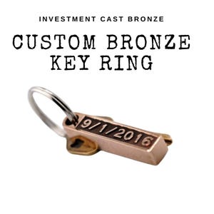 May include: A custom bronze key ring with a key-shaped charm engraved with the date "9/1/2016".
