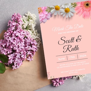 May include: A wedding invitation with a pink background, floral accents, and the text "Mark The Date" for Scott & Ruth, June 17th, 2024. A bouquet of purple and white flowers rests beside the invitation in a brown envelope.