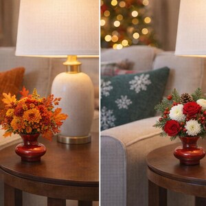 May include: Two floral arrangements in red vases sit on wooden tables. One features orange and yellow flowers with autumn leaves. The other has red and white flowers with pinecones and berries. Lamps with white shades are in the background.